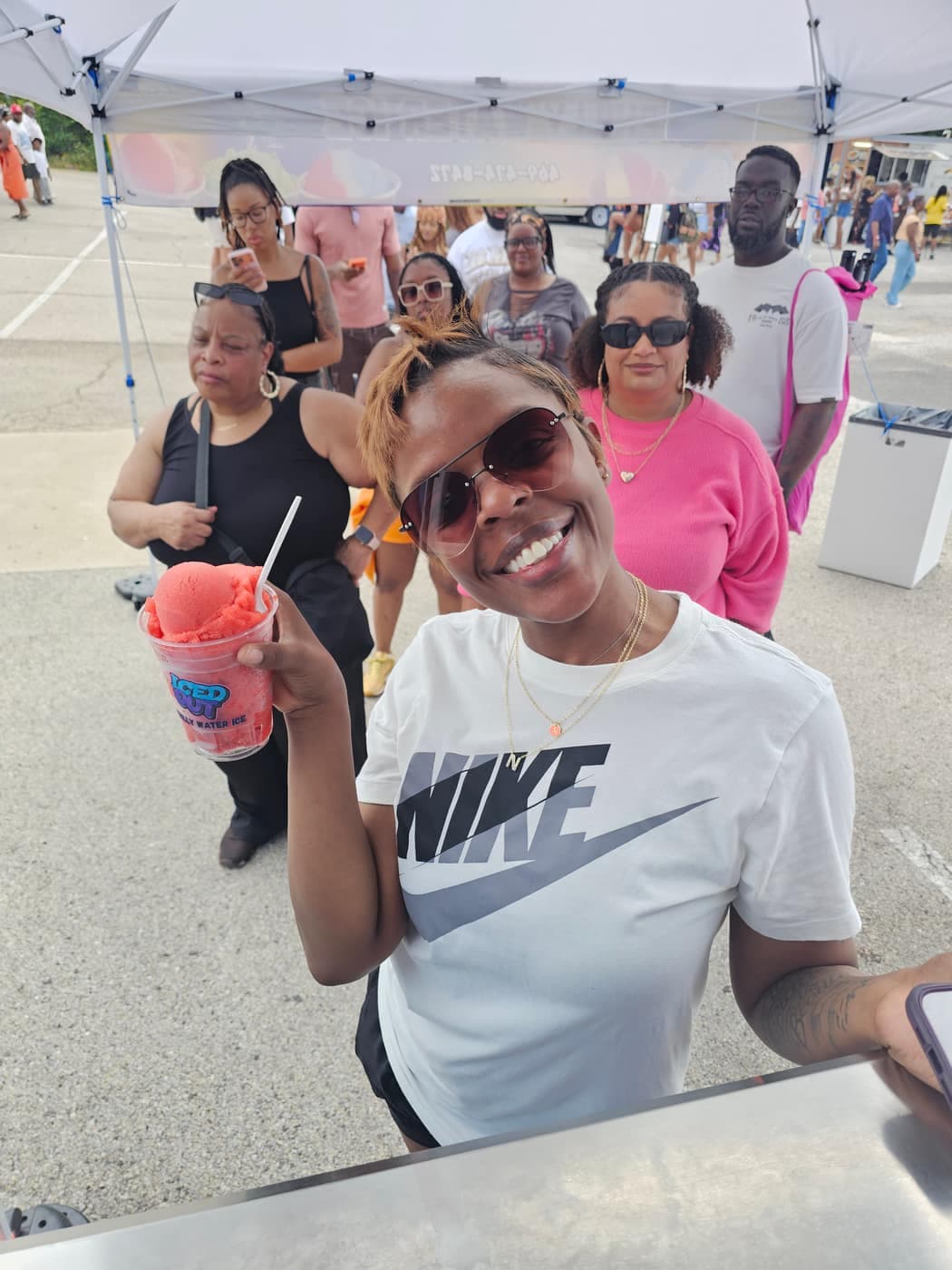 Happy customer holding a cup of strawberry Philly water ice