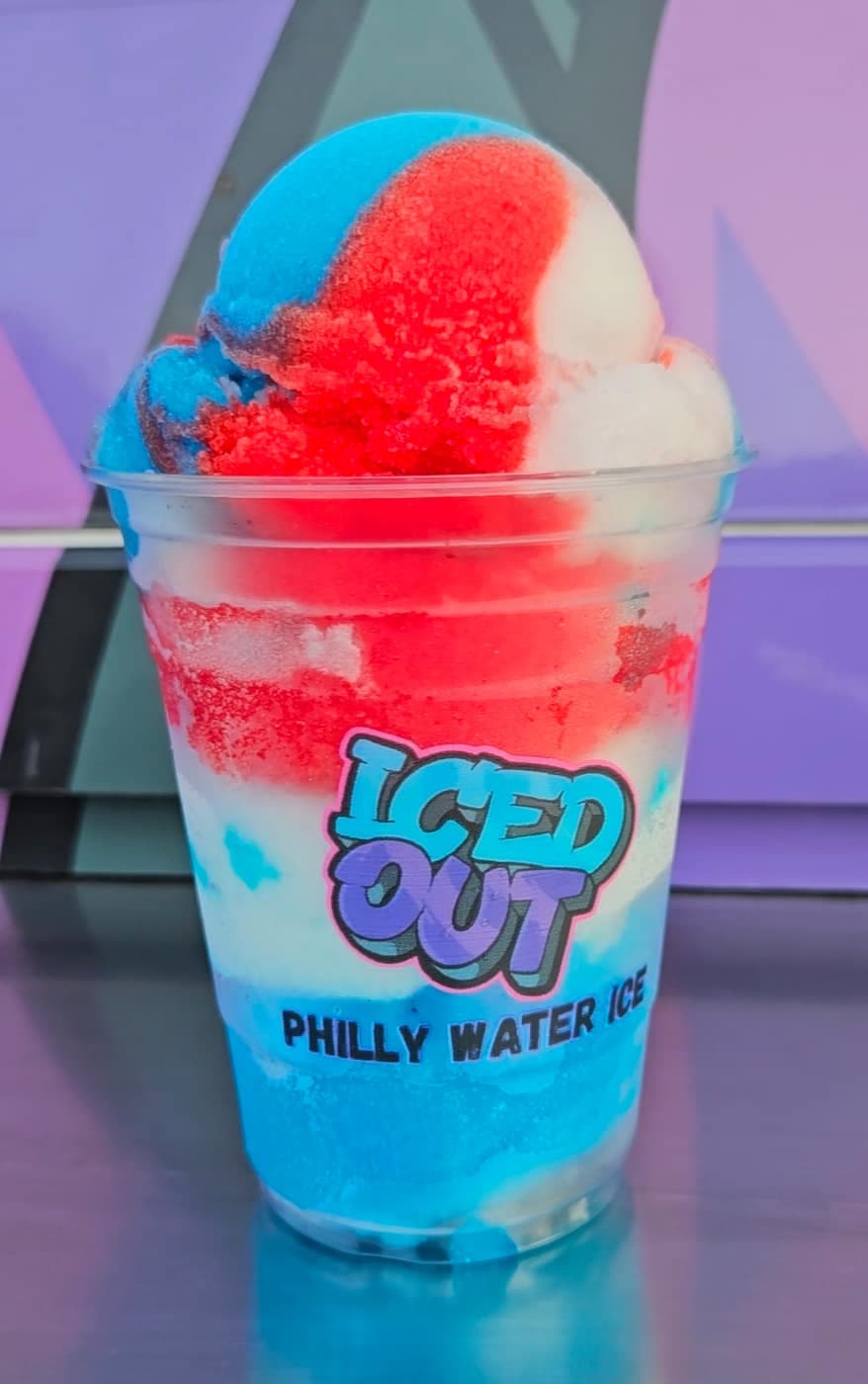 Close-up of a layered red, white, and blue Iced Out Philly water ice cup