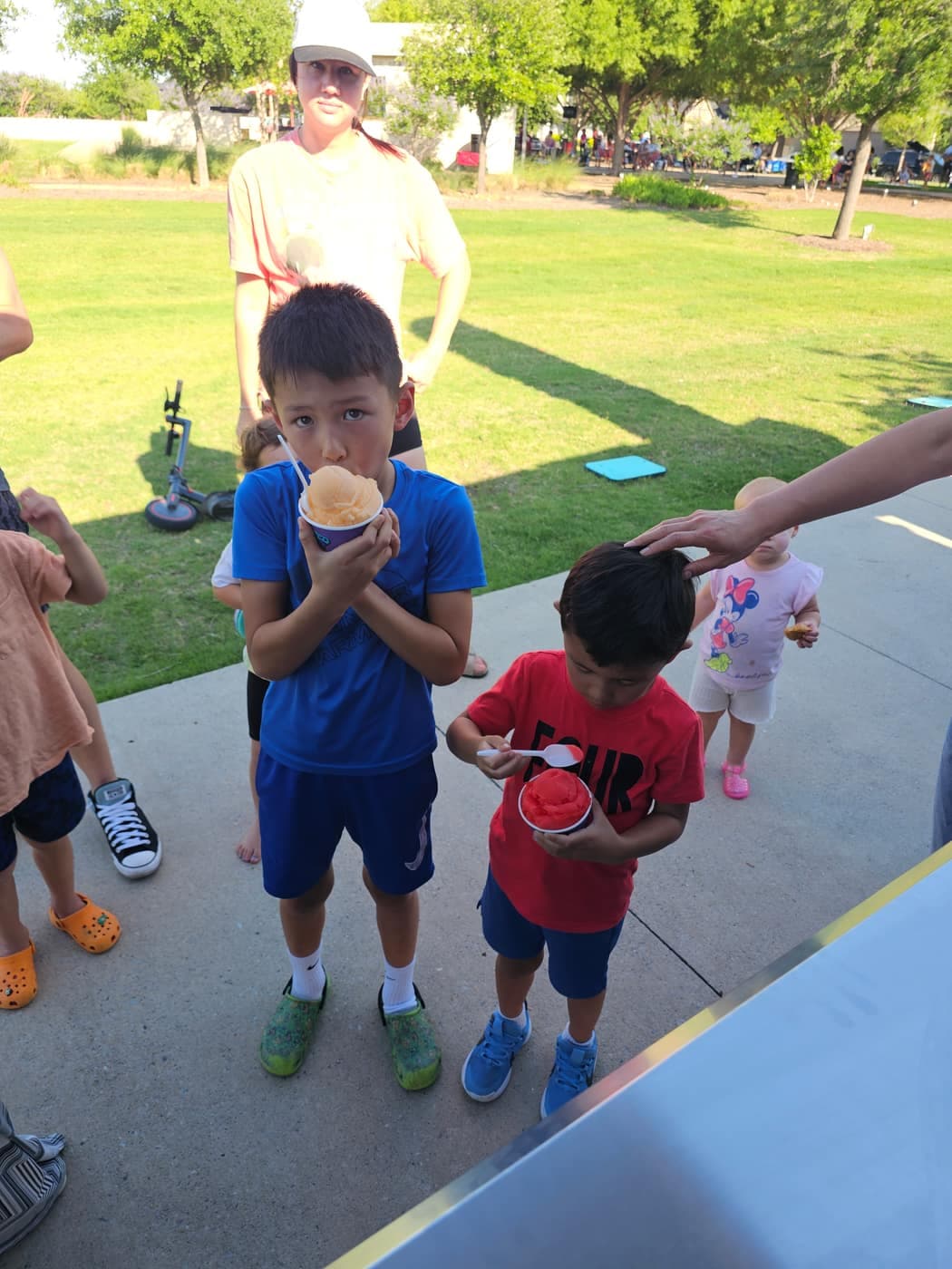 Kids holding cups of Iced Out Philly water ice
