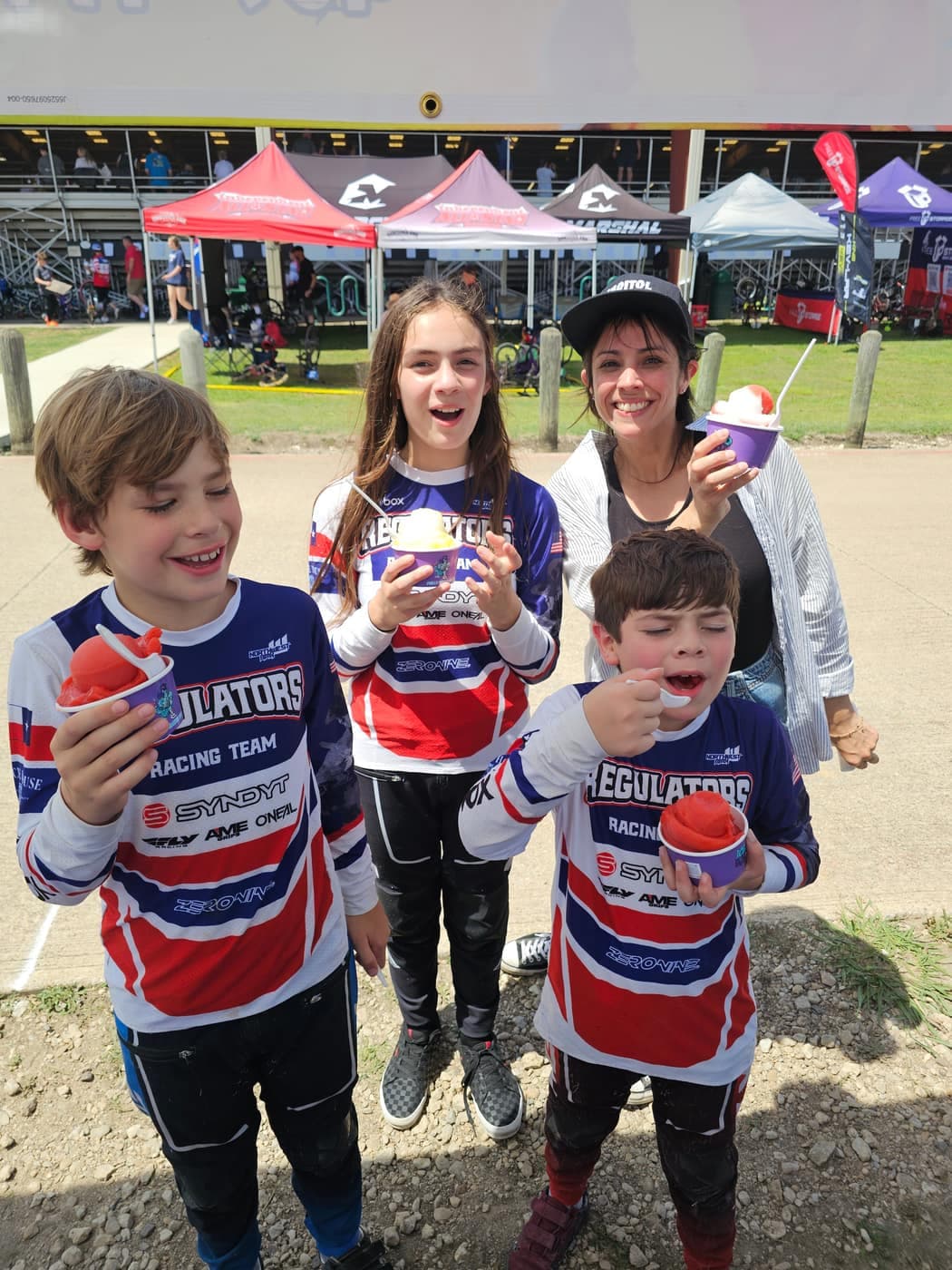 Children enjoying frozen treats at an outdoor fundraiser event
