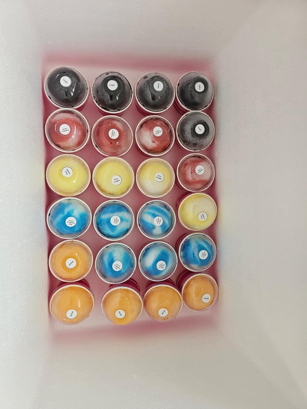 Colorful pre-scooped cups of Philly water ice arranged in rows