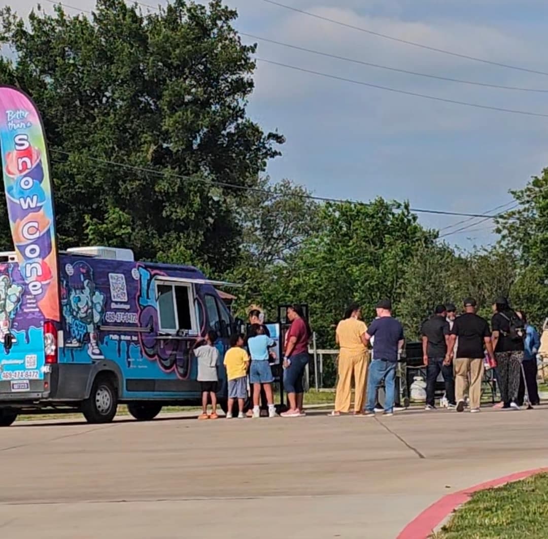 The Iced Out truck set up outdoors at a DFW community event